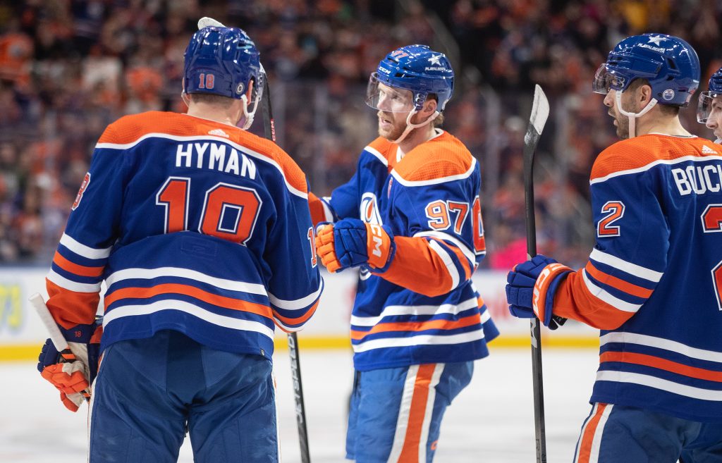 Edmonton Oilers' Zach Hyman (18), Connor McDavid (97) and Evan Bouchard (2) celebrate a goal against the Anaheim Ducks during second period NHL action in Edmonton on Saturday March 30, 2024.