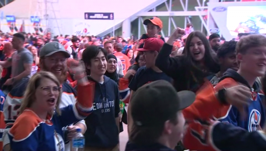 Edmonton Oilers fans cheer in a large crowd