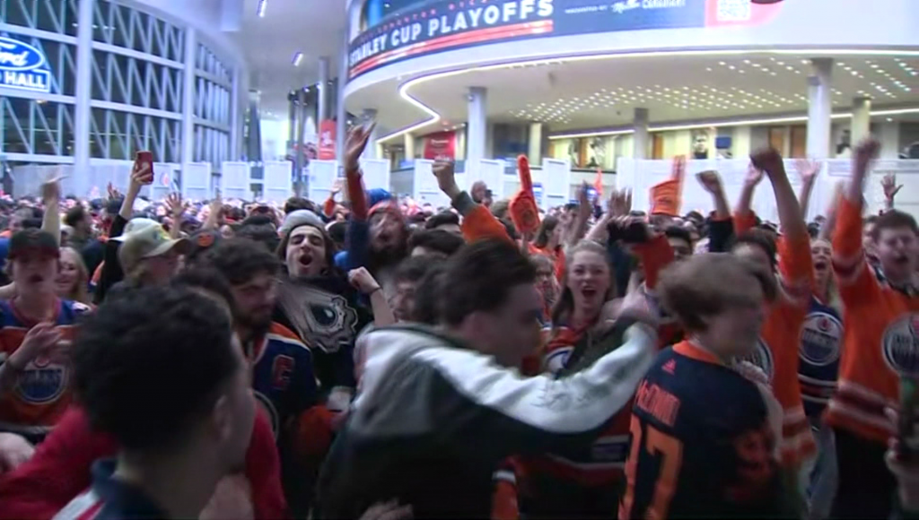 Edmonton Oilers fans cheer in a large crowd