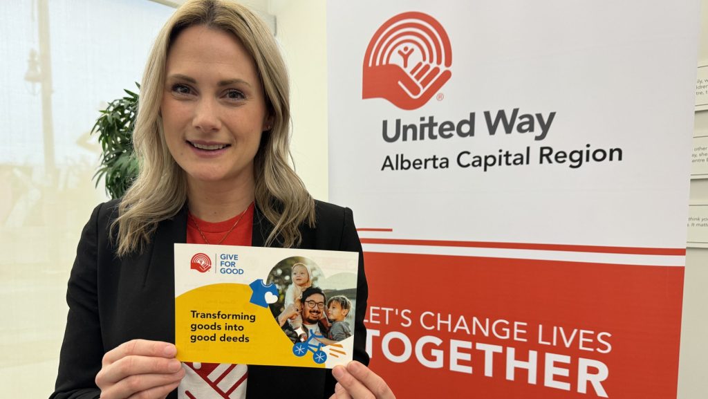 Meighan Sommer standing in front of United Way sign