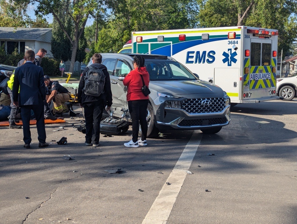 EMS attends to the driver of a motorcycle at the scene of a collision in northwest Edmonton Friday afternoon.