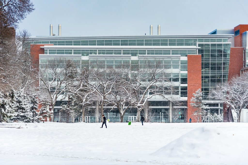 students walk across snowy university of alberta campus