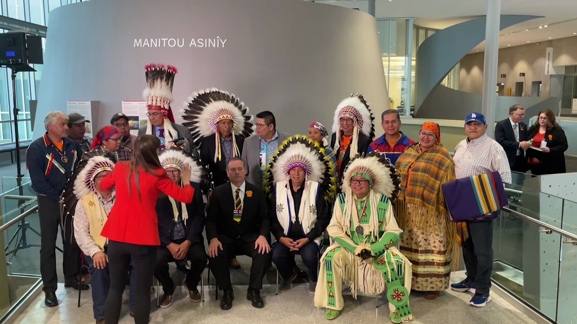 A group of people with Elder Leonard Bastien Premier Jason Kenney pose for a photo at the Royal Alberta Museum in Edmonton